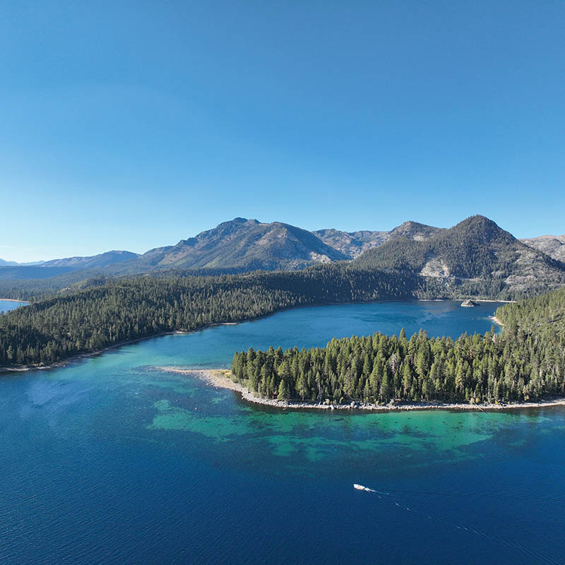 Aerial drone view of Emerald Bay on Lake Tahoe with crystal blue water and Fannette Island.